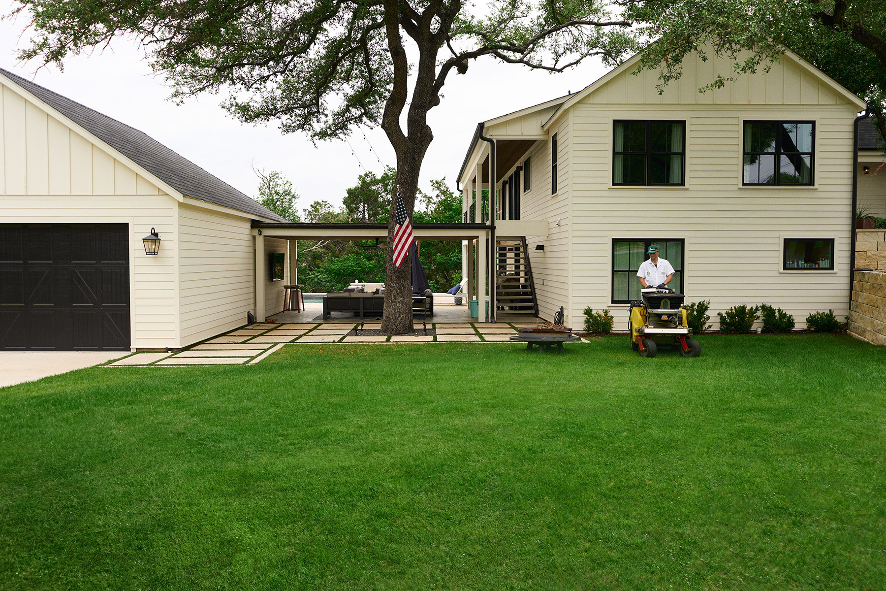 Lawn care tech applying treatment in West Austin, TX