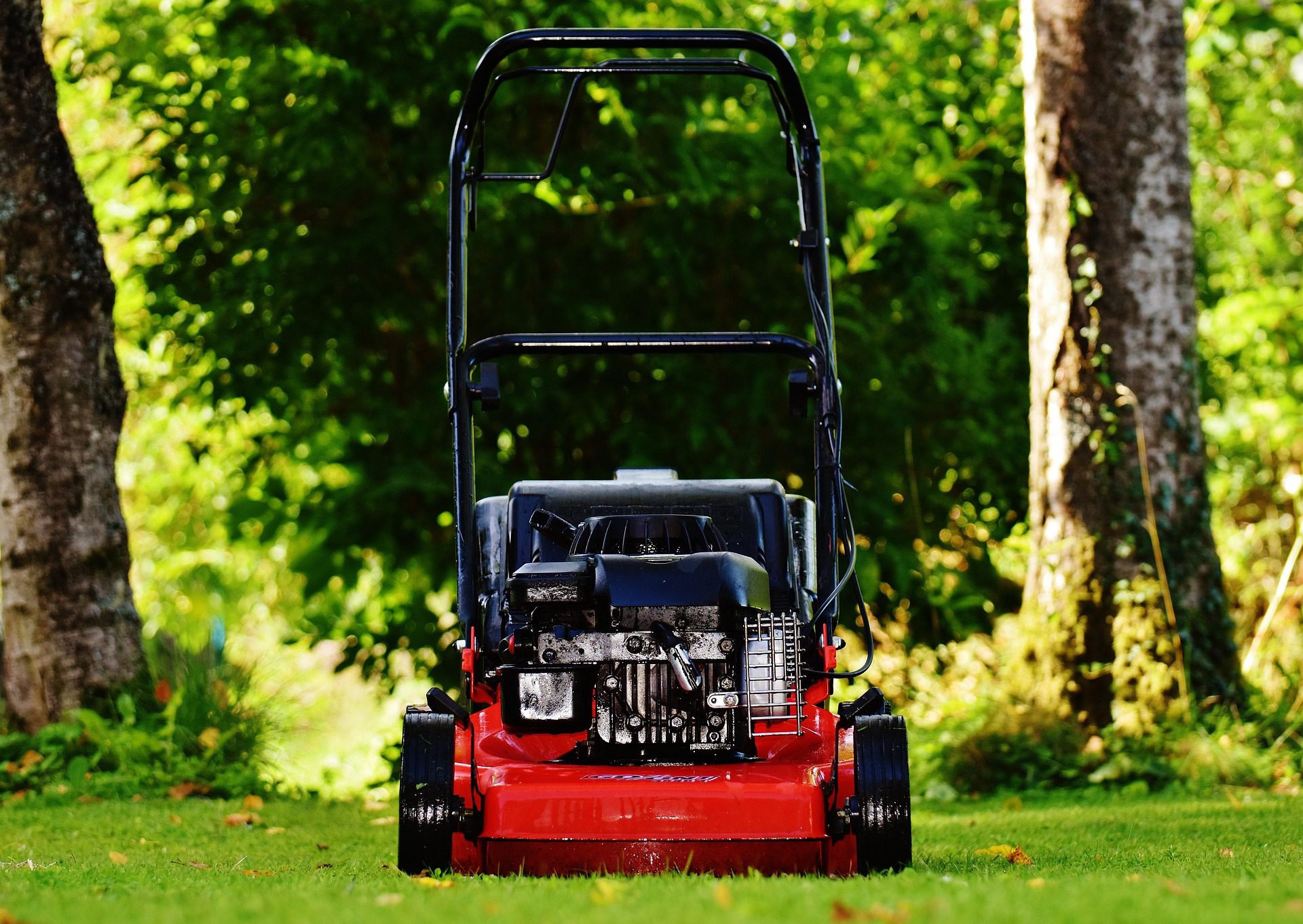 Sharpening a lawn mower blade before spring mowing for healthy grass in Austin Texas